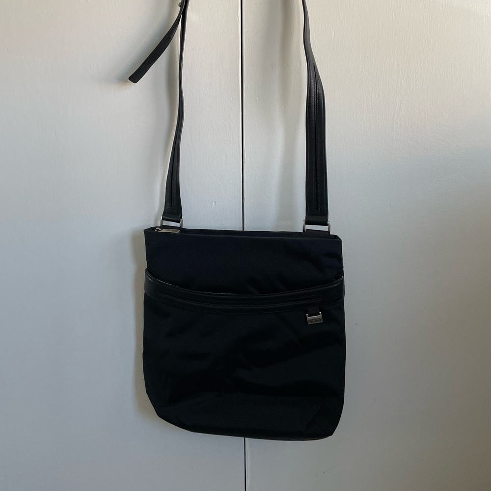 Tumi black cross body with leather strap